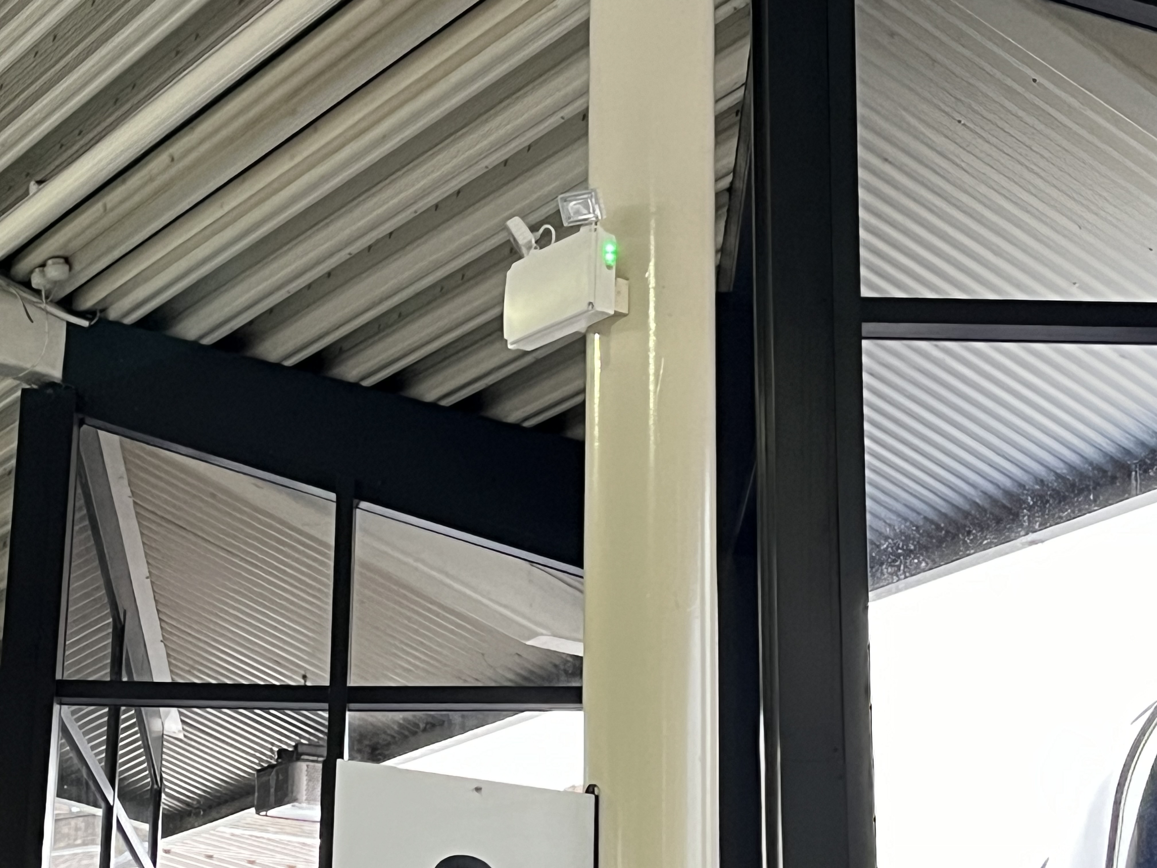 security camera attached to the top of a column in a building